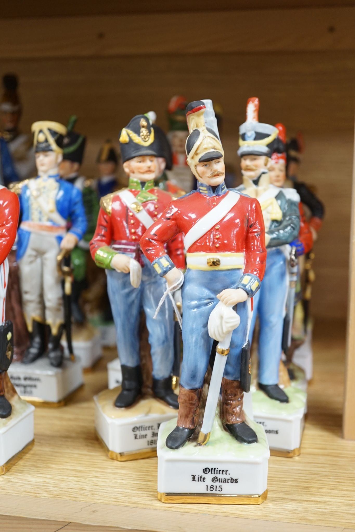 A collection of Continental porcelain figures of military soldiers, tallest 27.5cm